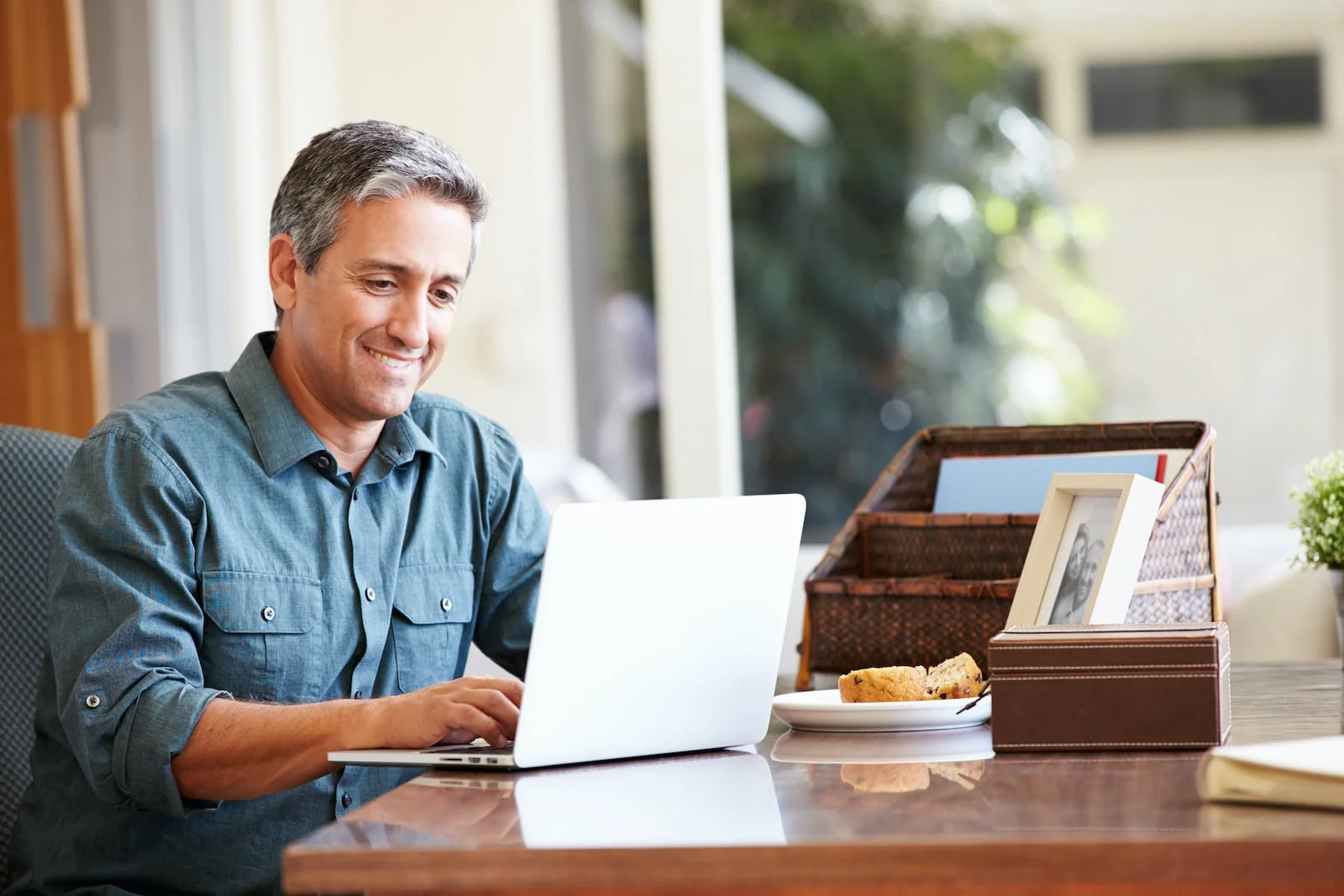 man_at_desk man at laptop smiling at desk